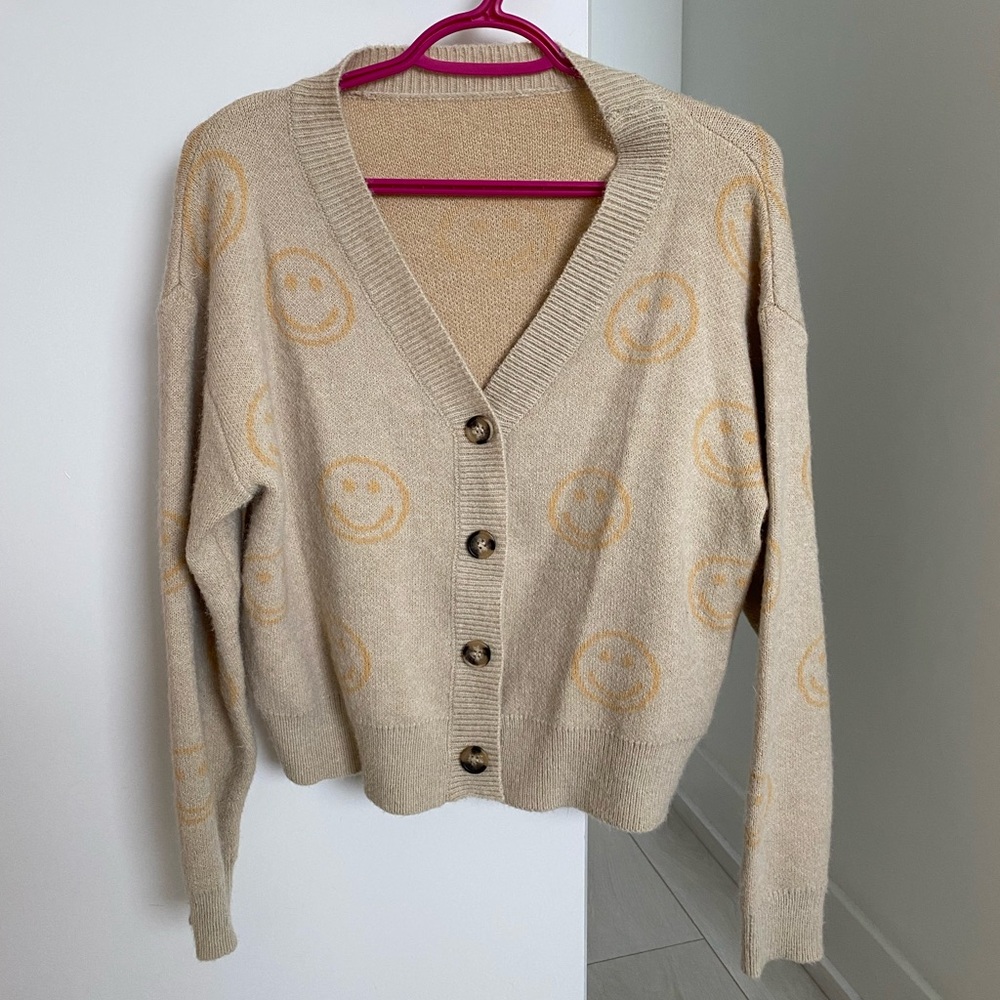 Beige slightly cropped cardigan with smiley faces